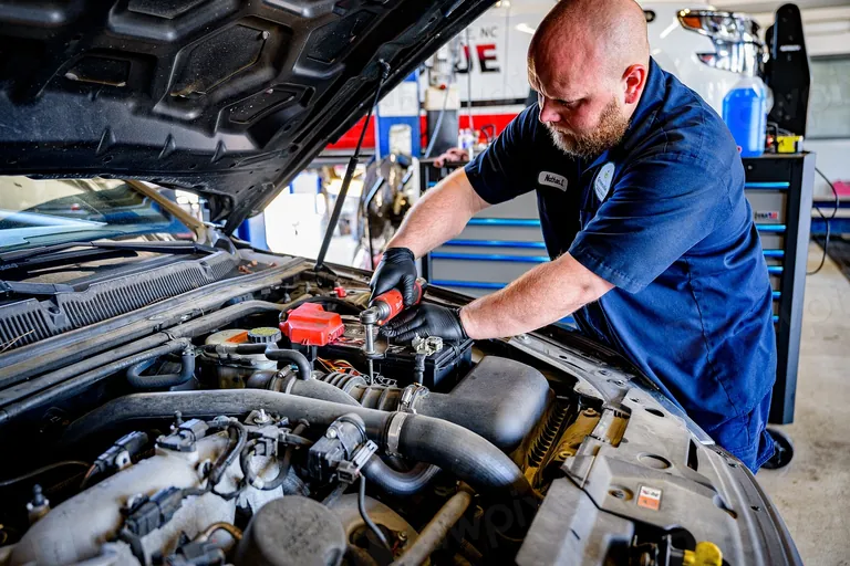 Mechanic working under the hood