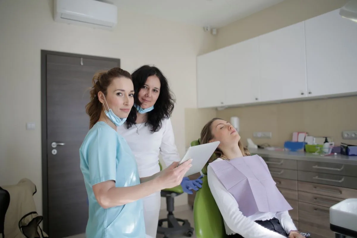 Friendly clinic team with a patient